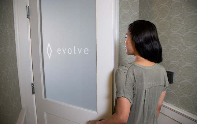 a patient leaving through the Evolve logo doorway